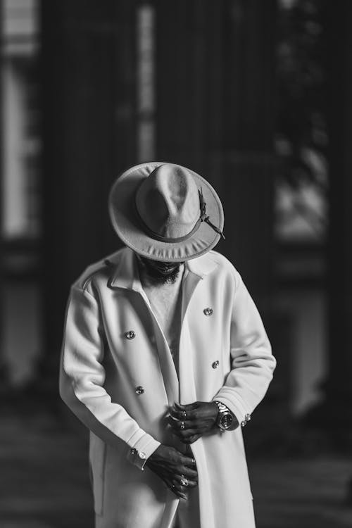 Man in Hat and Coat in Black and White