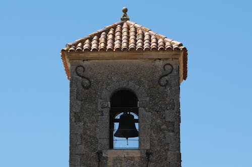 Stone Bell Tower against Blue Sky