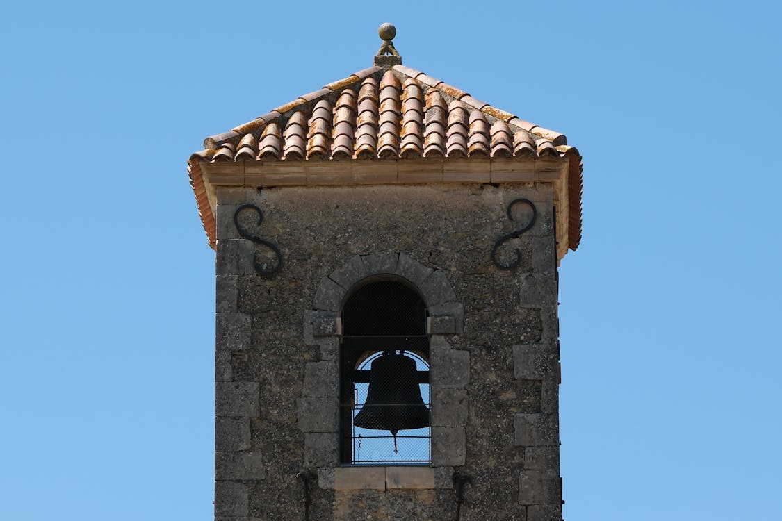 Stone Bell Tower against Blue Sky