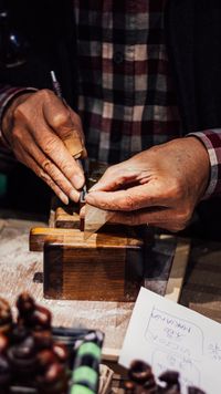 Artisan hand-carving a wooden seal — photo by Victor Lucas on Pexels