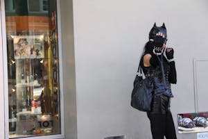 Woman Leaning on Wall Wearing Black Cat Costume