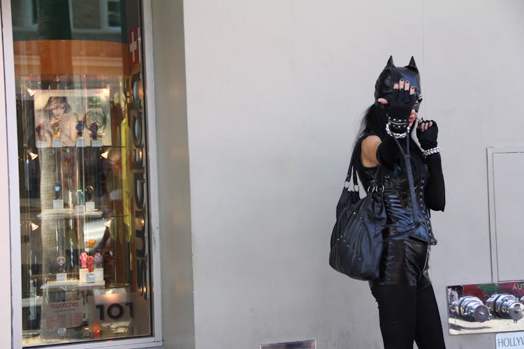 Woman Leaning On Wall Wearing Black Cat Costume