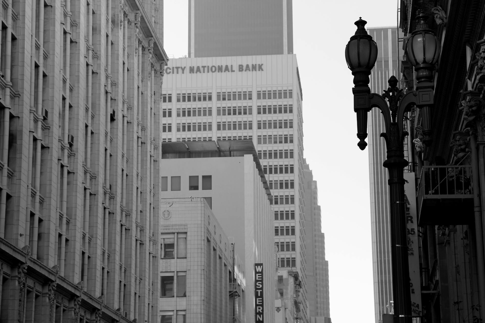 Grayscale photo of skyscrapers including City National Bank in urban setting.