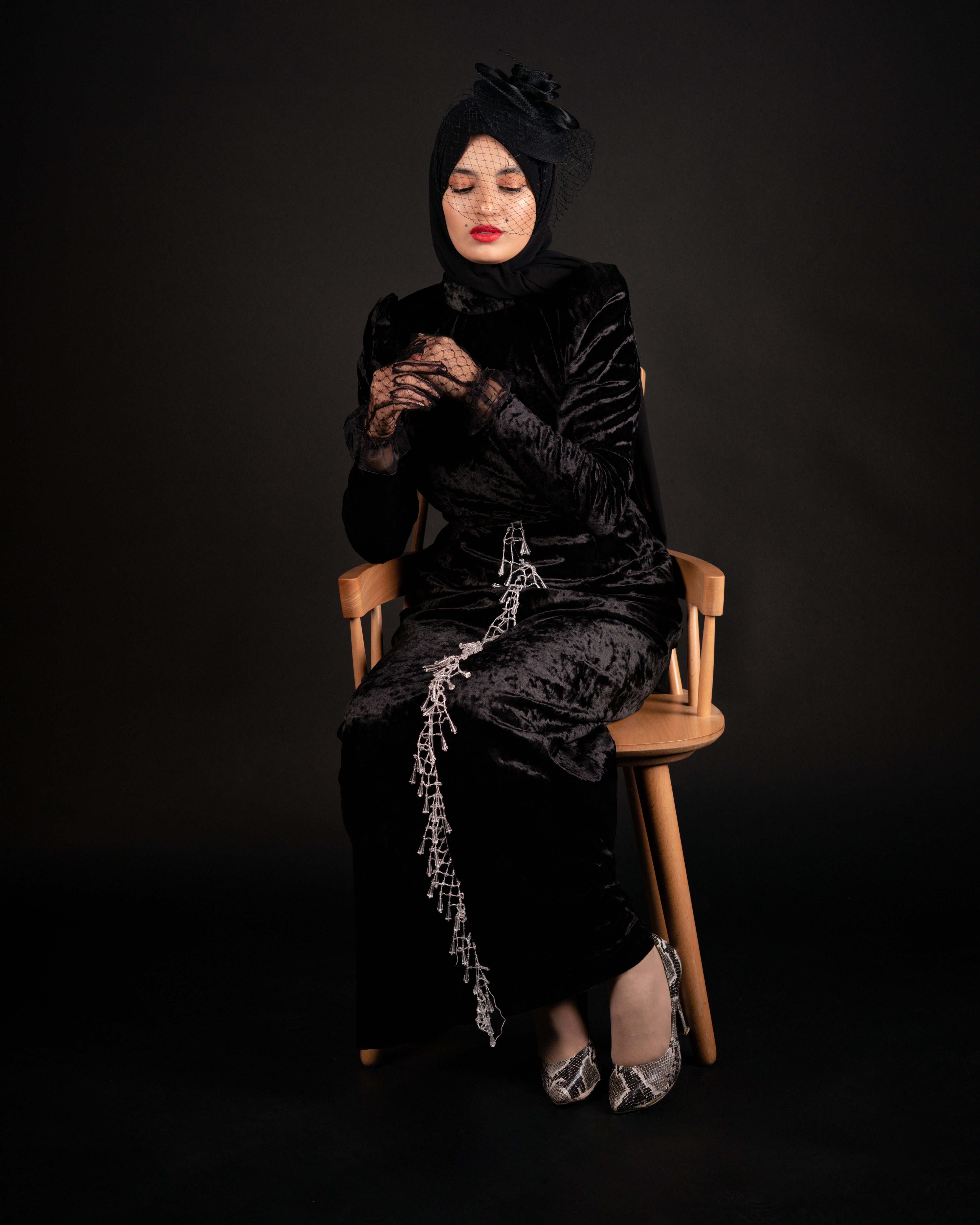 Model in a Long Black Satin Dress and a Fascinator Headpiece  Free Stock  Photo