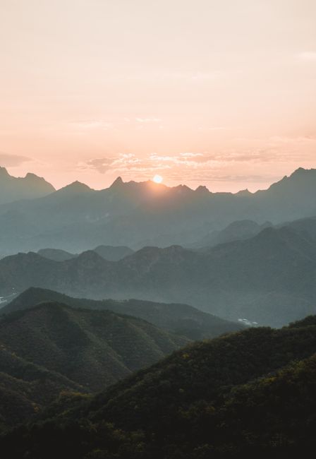 A breathtaking aerial view of China's mountains at sunset, showcasing natural beauty and dramatic scenery.