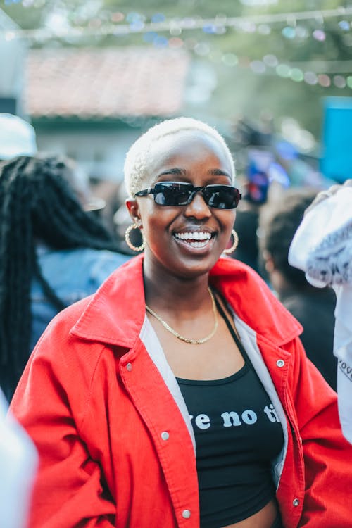Smiling Woman in Sunglasses and with Dyed, Blonde Hair