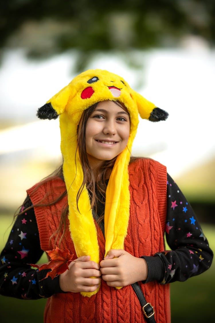 Portrait Of Smiling Woman In Pokemon Hat