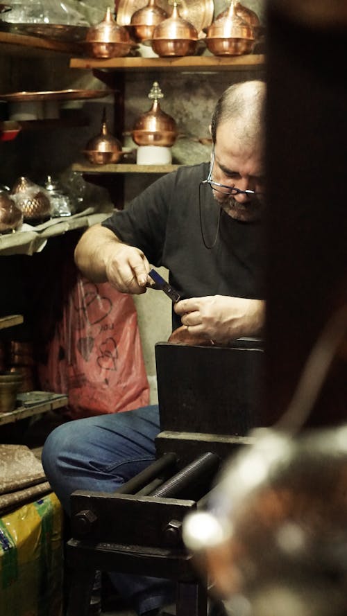 Blacksmith Artist Working with Hand Tools on a Brass Bowl