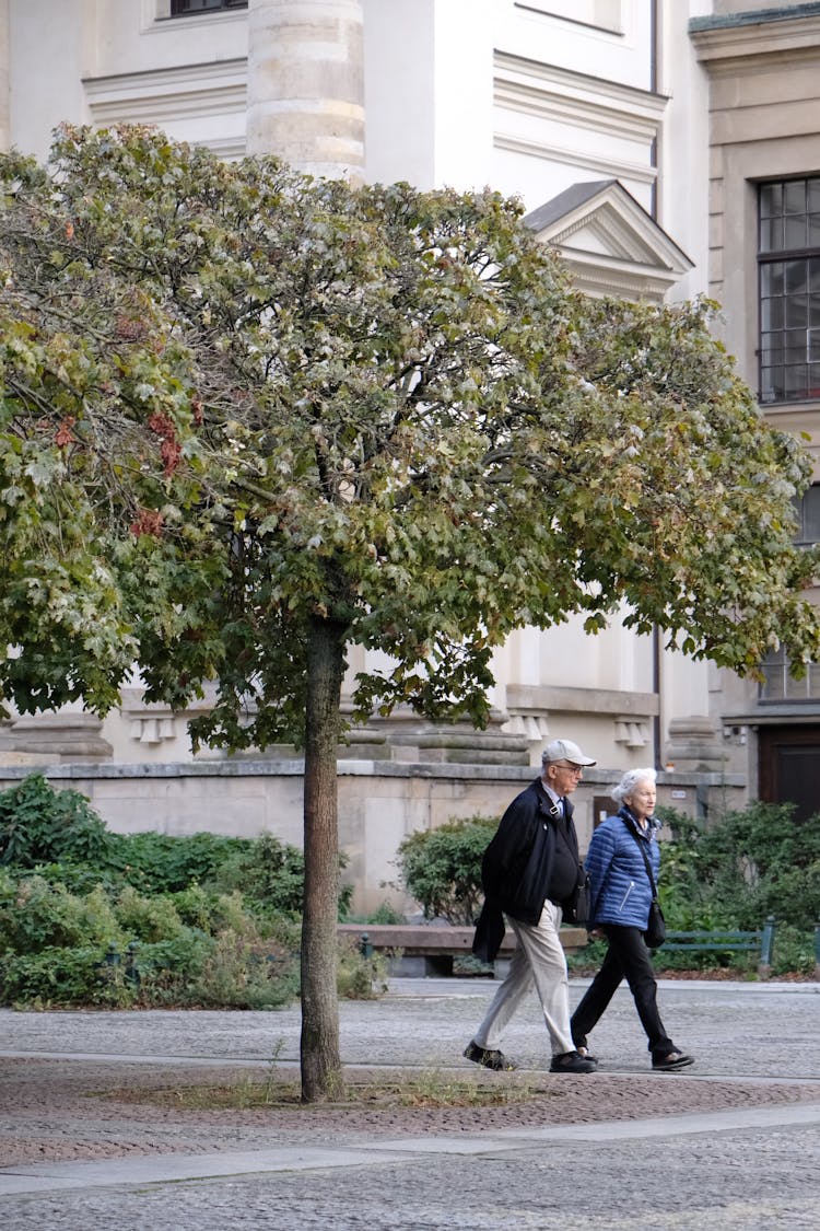 A Senior Couple Walking Down The Street