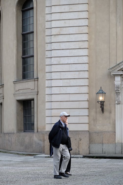 Elderly Man in Cap Walking on Street