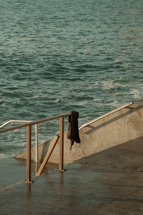 Cloth Hanging on Handrail on Sea Shore