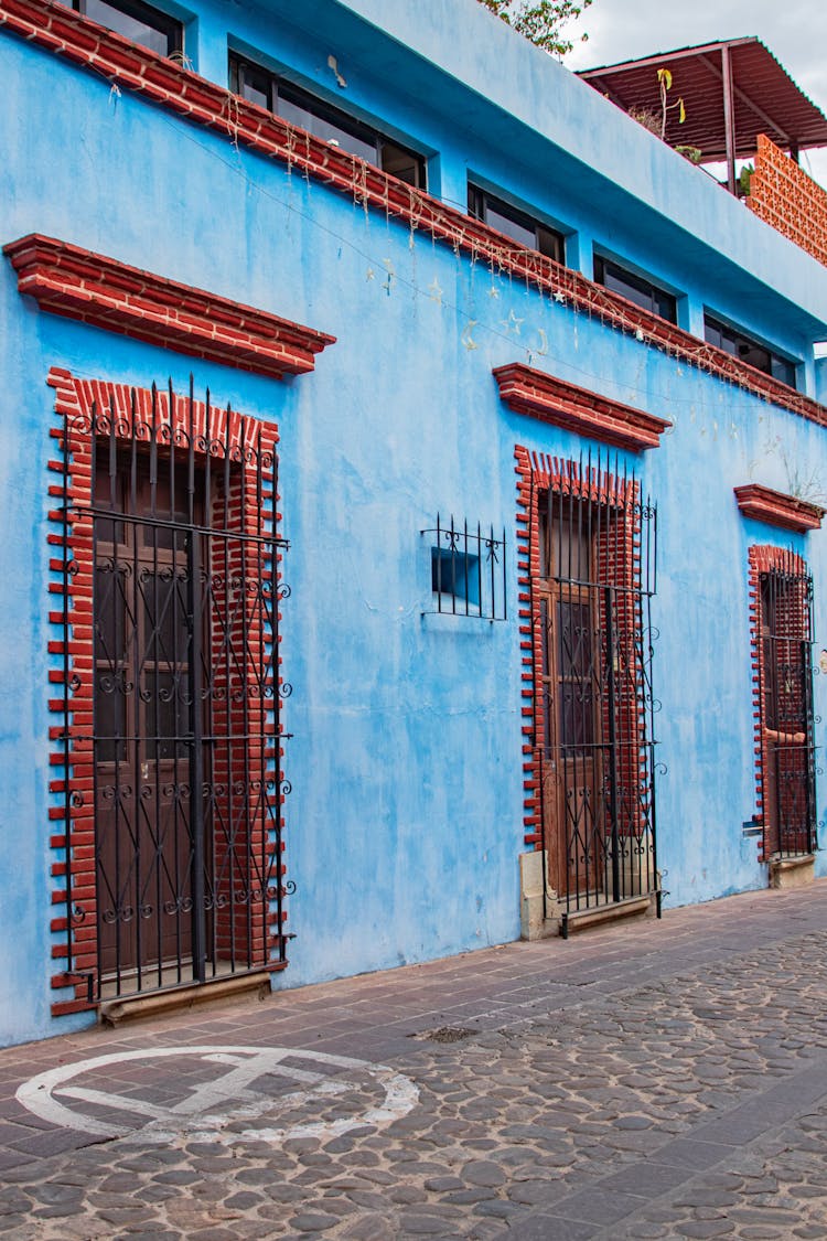 Doors Of The Blue Building Secured With Bars