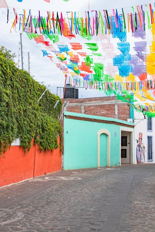 Colorful Decorations over the Cobblestone Alley of Mexican City Oaxaca