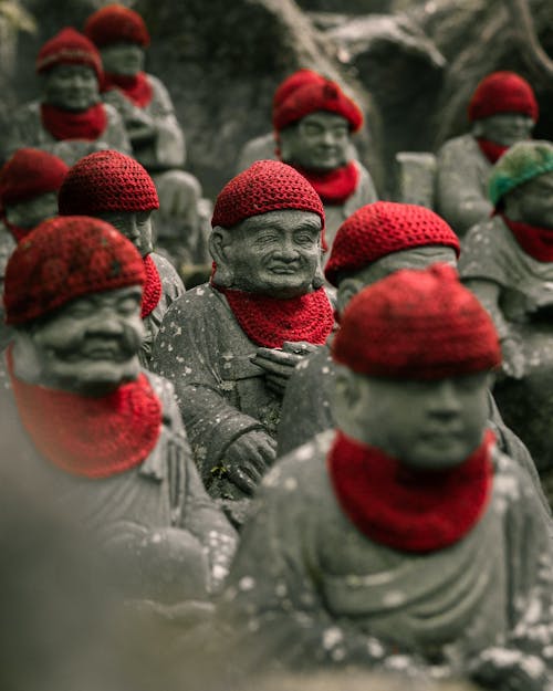 Monk Statues Wearing Red Knitted Hats
