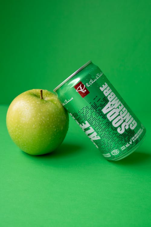 Green Can of Ginger Ale From President Choice Resting on a Green Apple