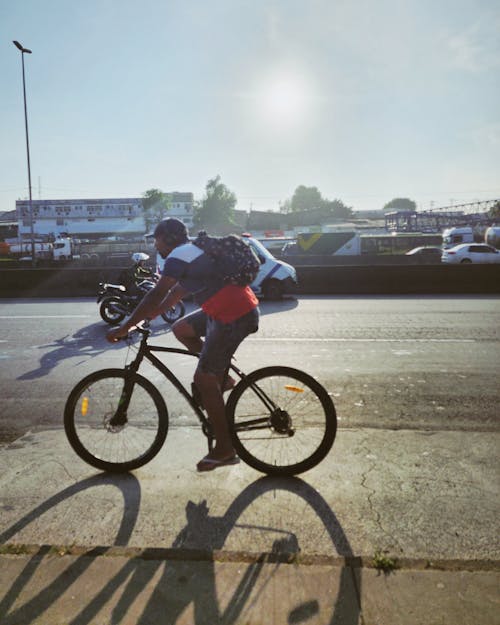 Man Riding Bicycle on Street