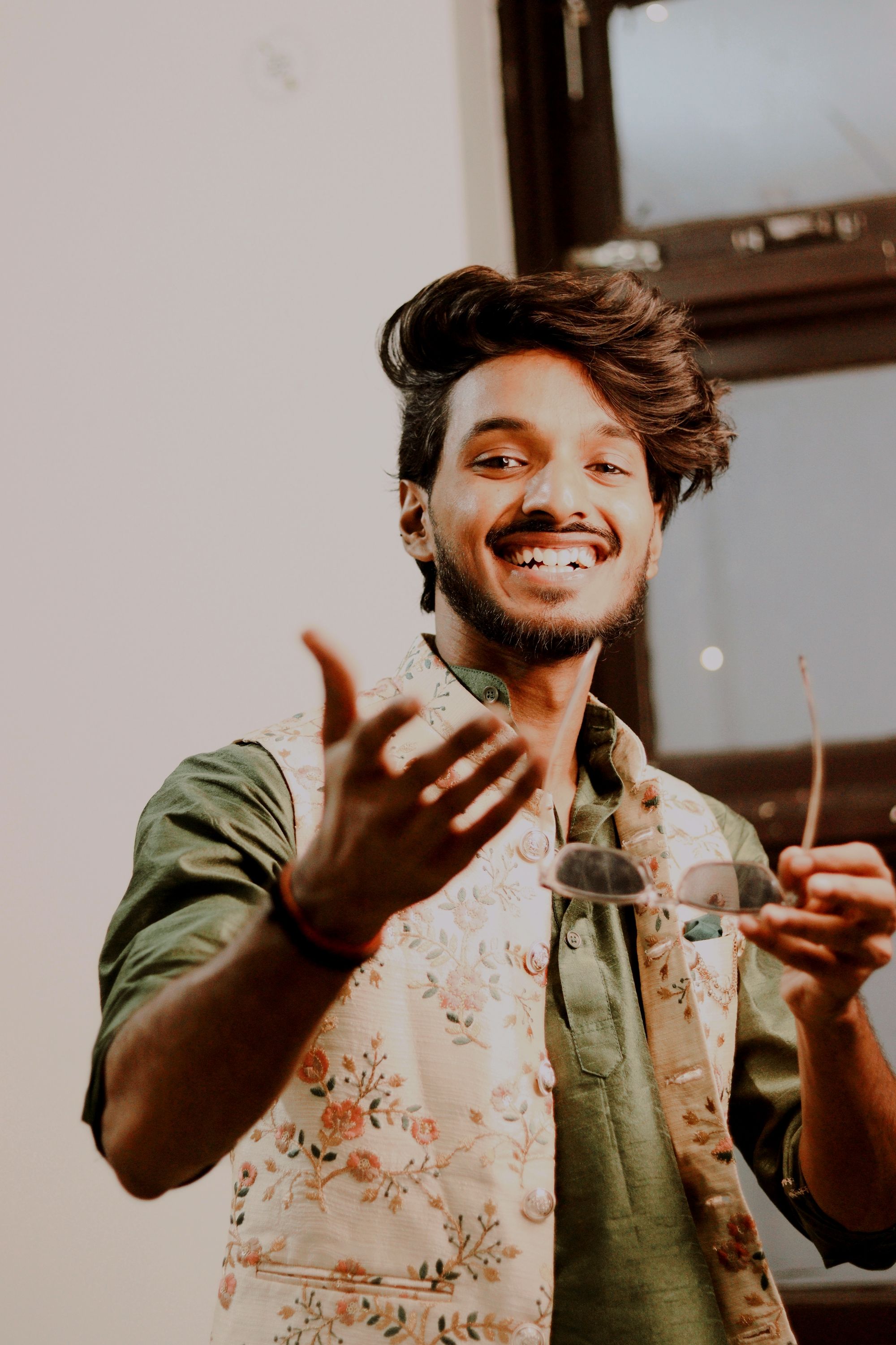 Smiling Man in a Floral Vest · Free Stock Photo