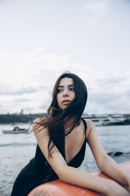 Free Elegant portrait of a woman with flowing hair by the Bosphorus, Istanbul. Stock Photo