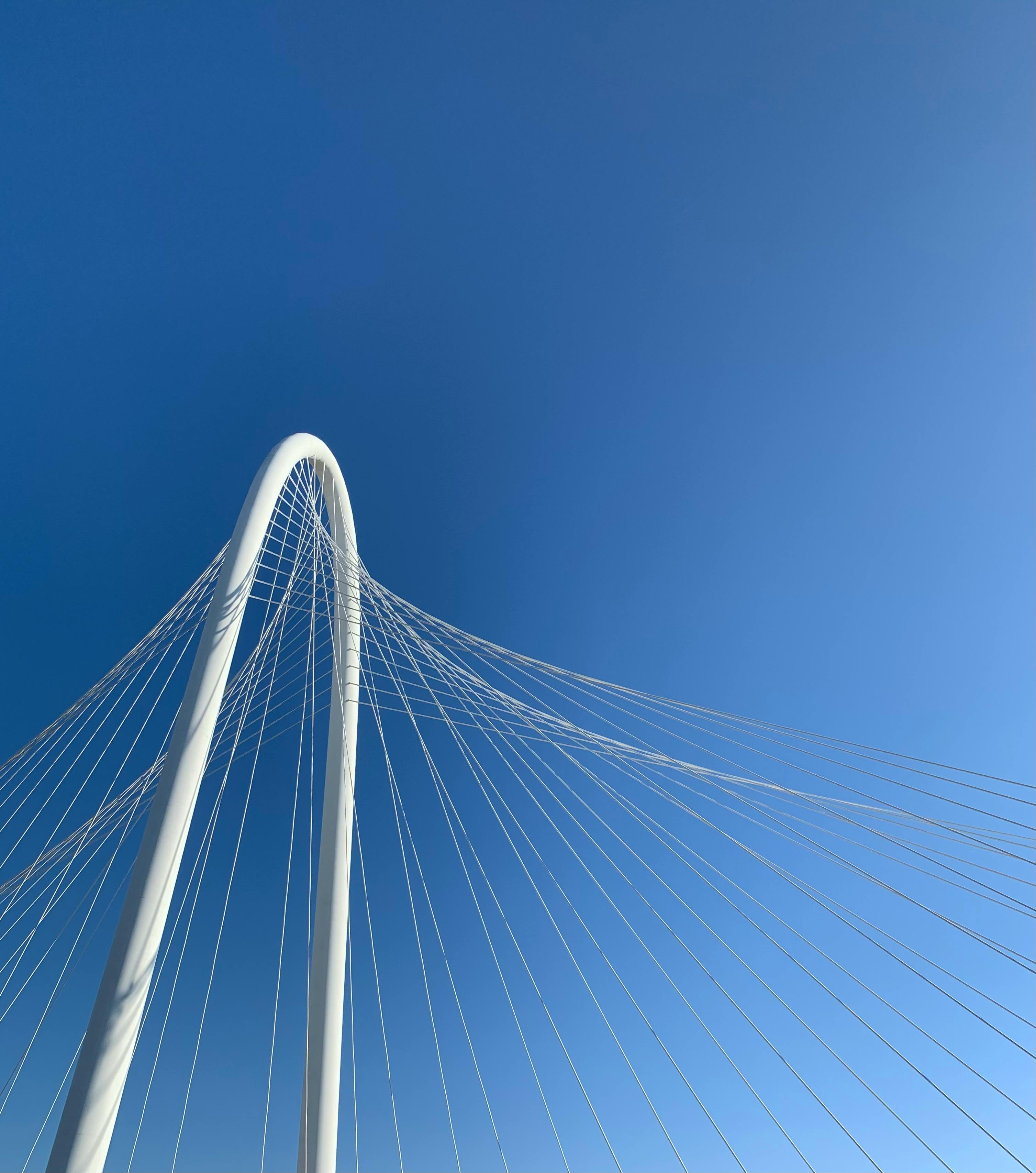 Low angle view of the Margaret Hunt Hill Bridge in Dallas with clear blue skies and elegant suspension cables.