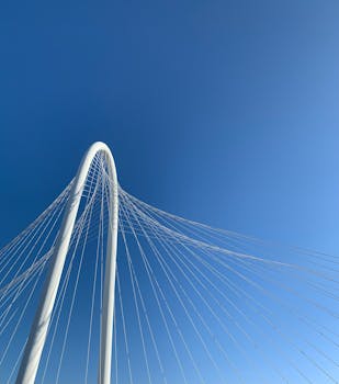 Low angle view of the Margaret Hunt Hill Bridge in Dallas with clear blue skies and elegant suspension cables.