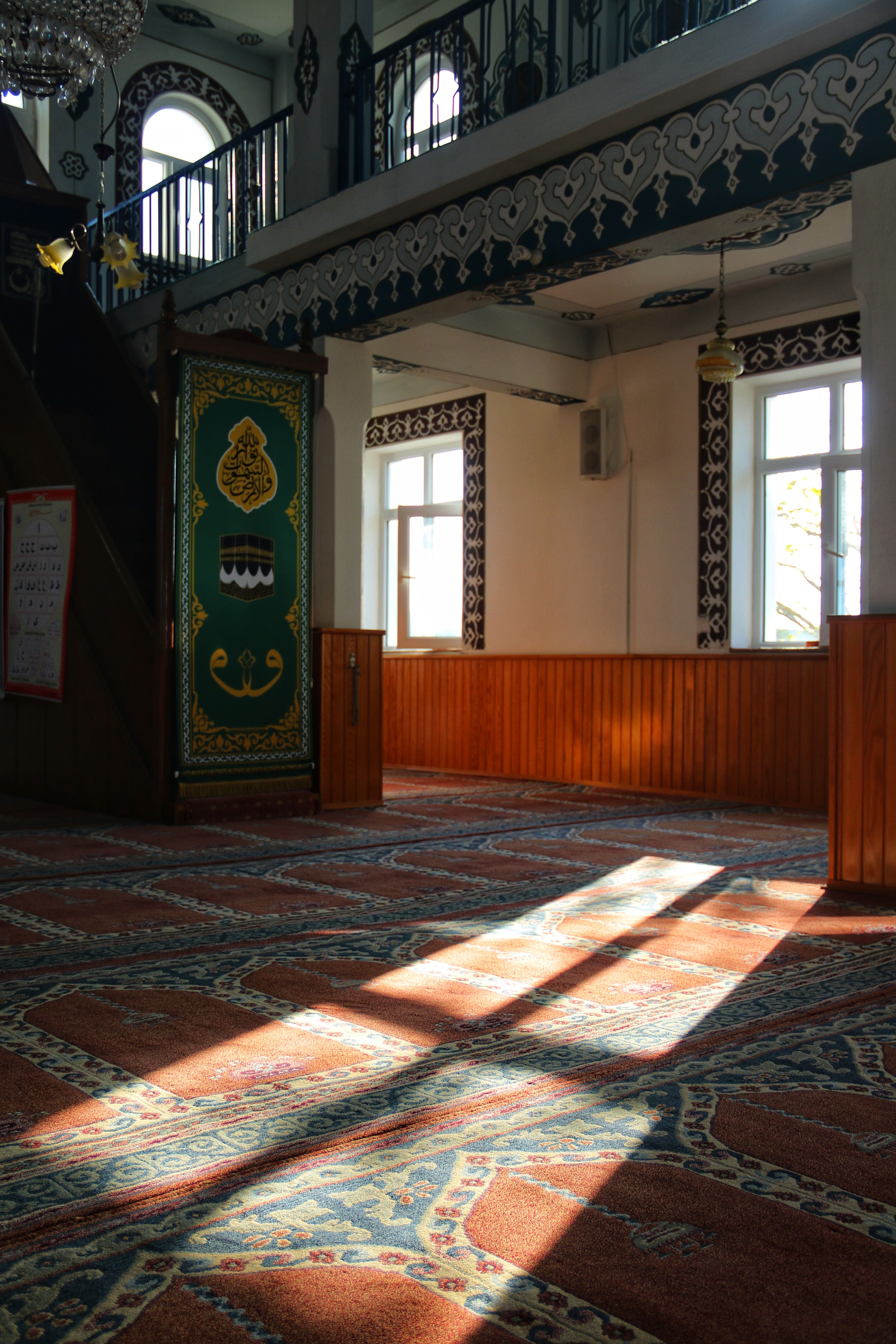 Peaceful mosque interior with ornate carpet