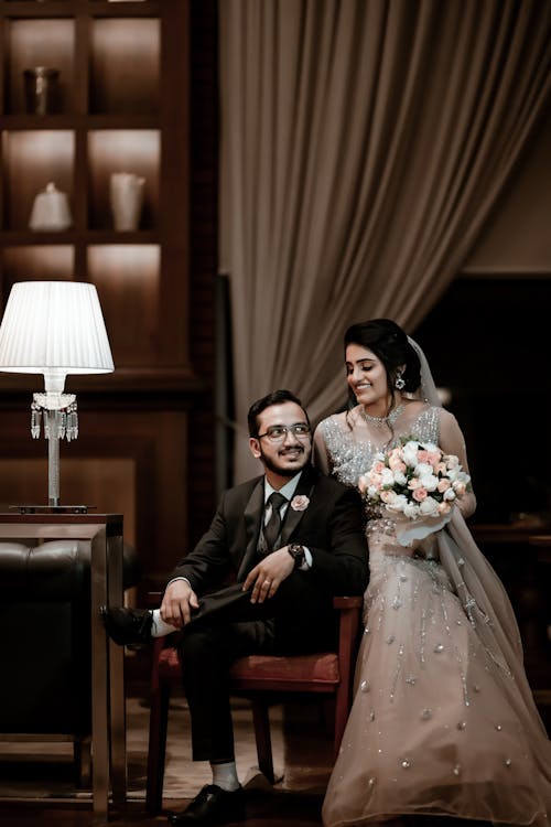 Smiling Newlyweds Sitting on Armchair