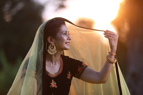 Smiling Woman in Yellow Veil at Sunset