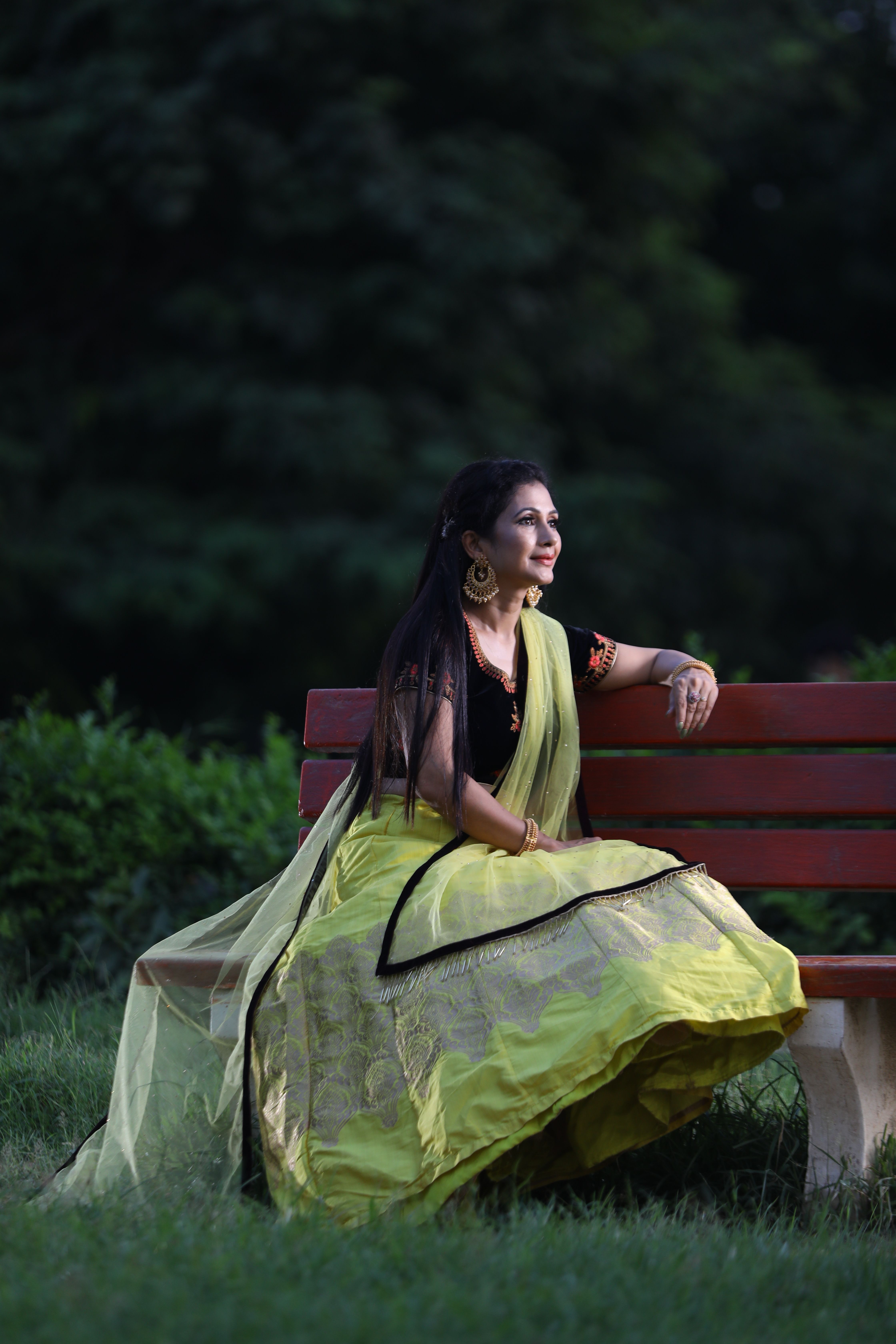 Woman in Traditional Clothing Sitting with Big Leaf · Free Stock Photo