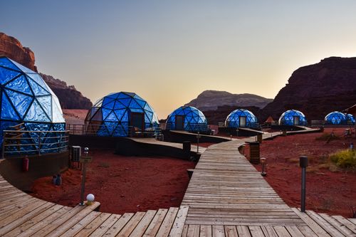 Free Explore luxury dome tents at a unique desert glamping site, blending modern design with natural beauty. Stock Photo