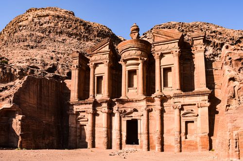 Free Explore the ancient architecture of Al Khazneh, Petra's iconic rock-carved structure in Jordan's desert landscape. Stock Photo