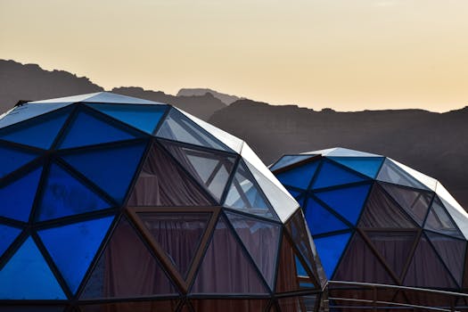 Geodesic domes in the Wadi Rum desert, Jordan, capturing a serene sunset backdrop.