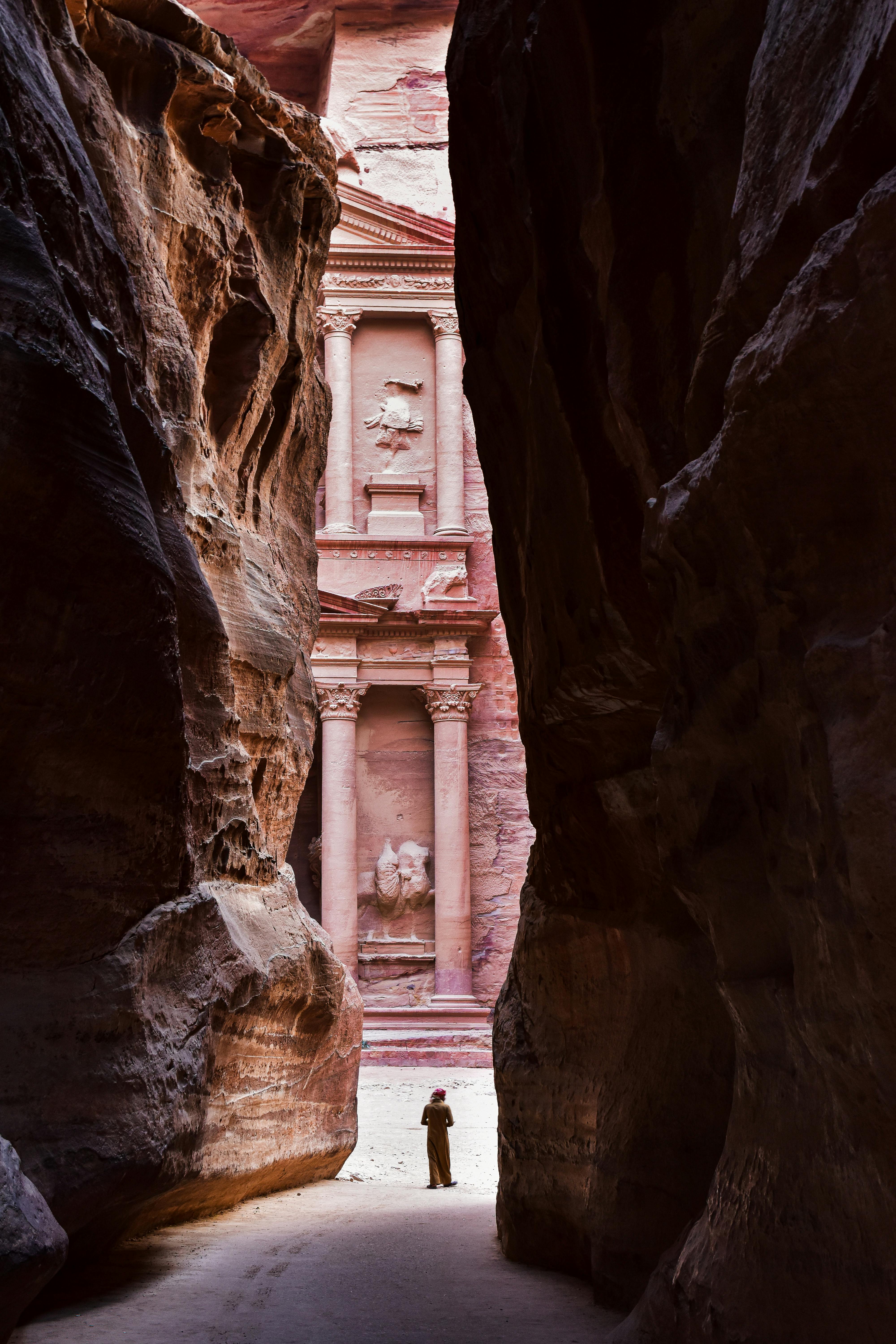 columns of the treasury in petra behind rocks