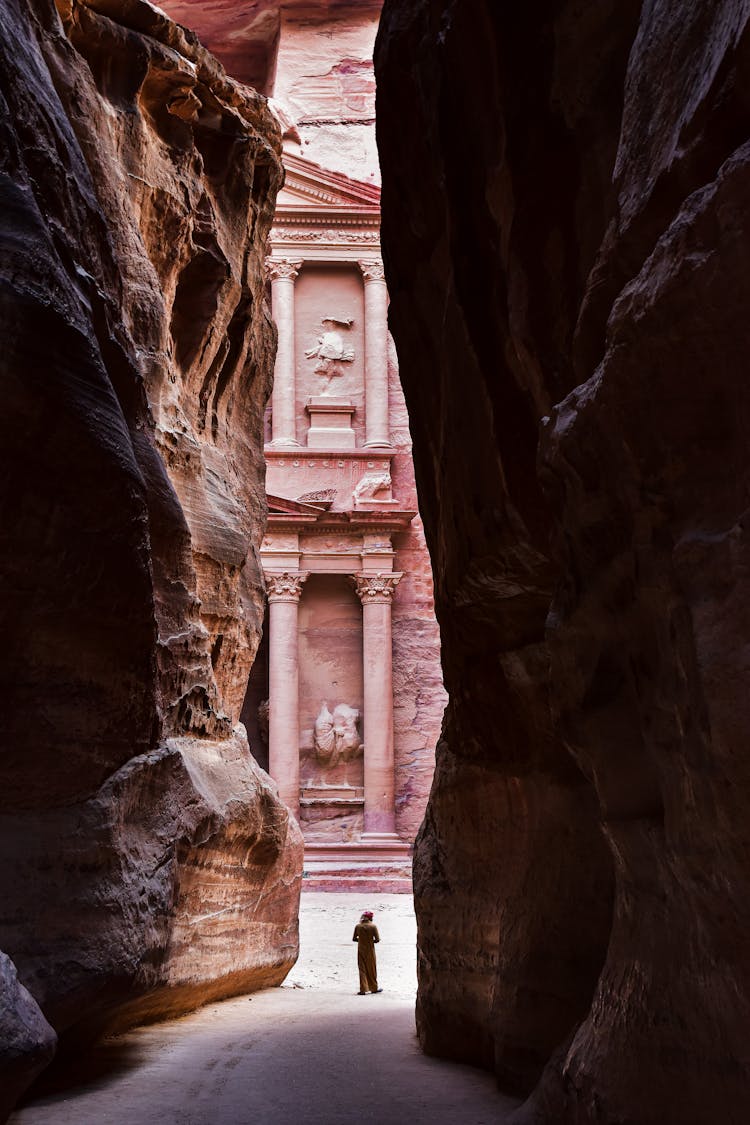 Columns Of The Treasury In Petra Behind Rocks