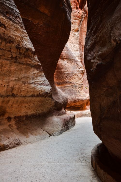 Free Discover the stunning sandstone formations of Petra's narrow canyon passageway. Stock Photo