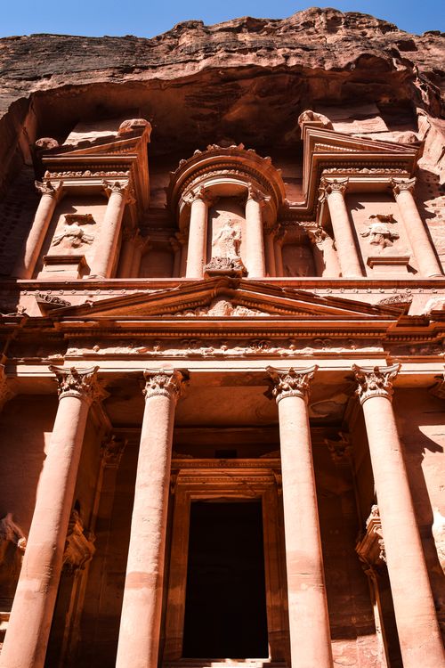Free Explore the iconic ancient architecture of Petra, featuring detailed stone carvings and columns. Stock Photo