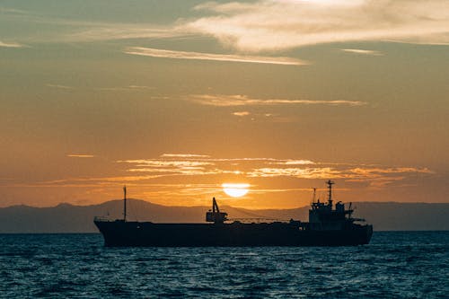 Silhouette of Cargo Ship at Sunset