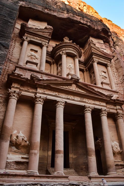 Free Discover the iconic facade of The Treasury in Petra, Jordan, captured in warm sunset light. Stock Photo