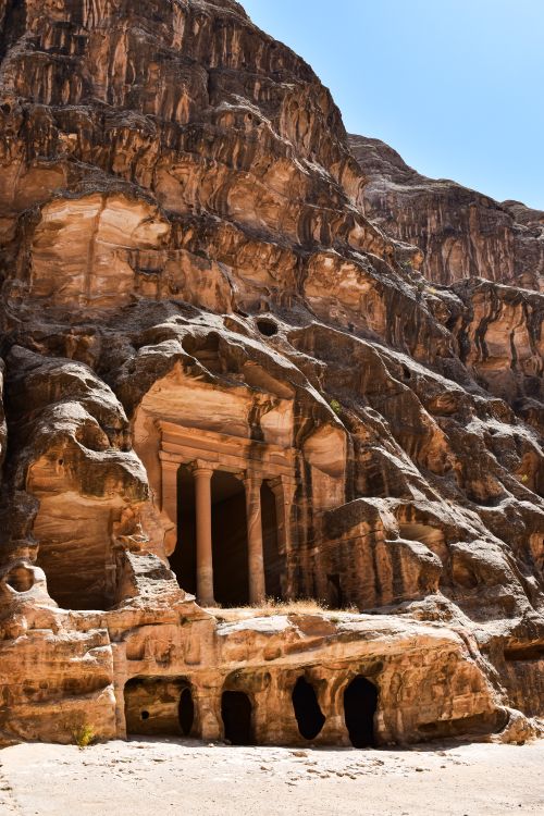 Free Explore the ancient cave carvings of Petra's iconic rock-cut architecture in Jordan. Stock Photo