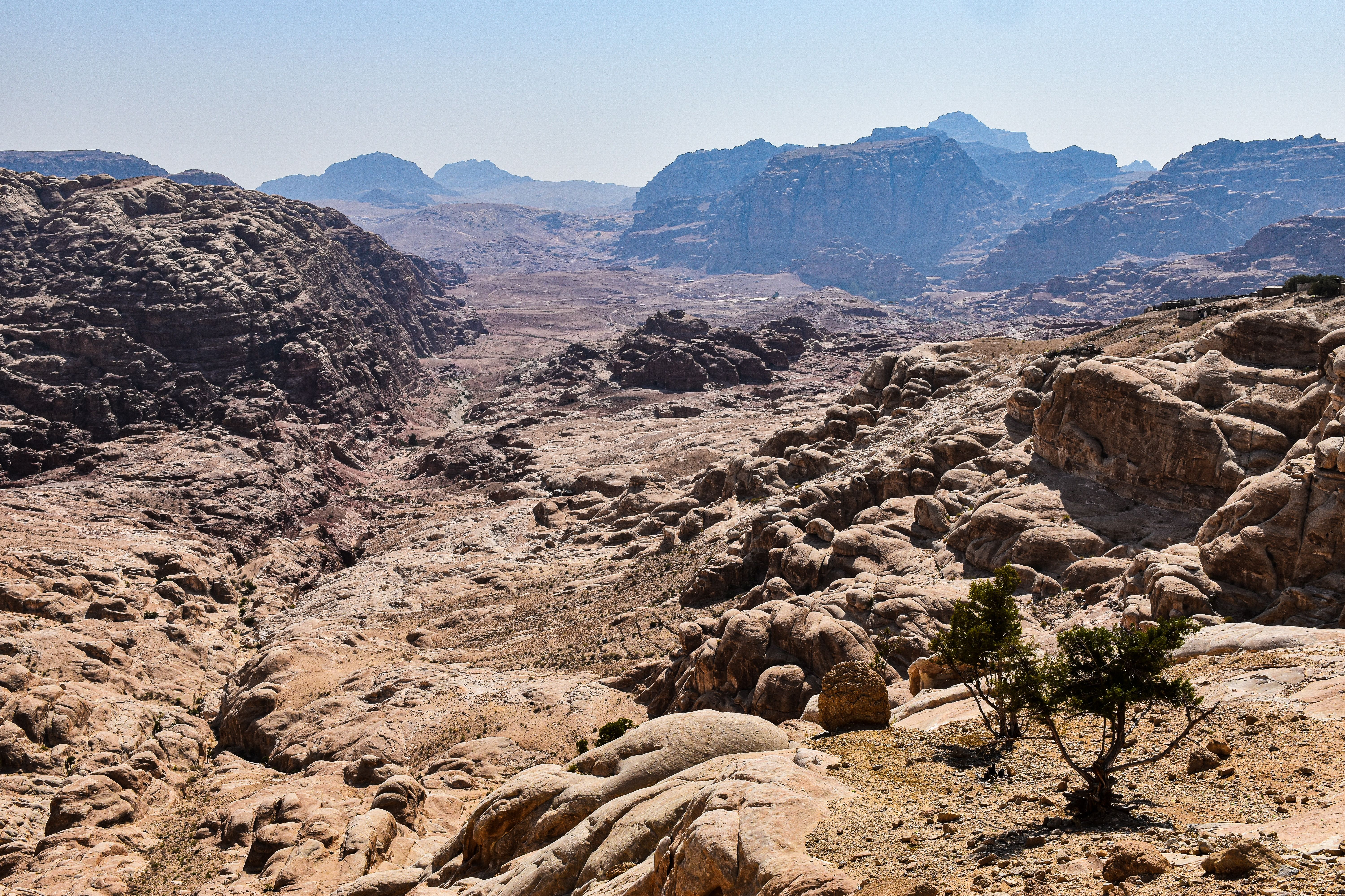 Breathtaking view of arid desert landscape and rocky formations under the bright sun in Jordan.