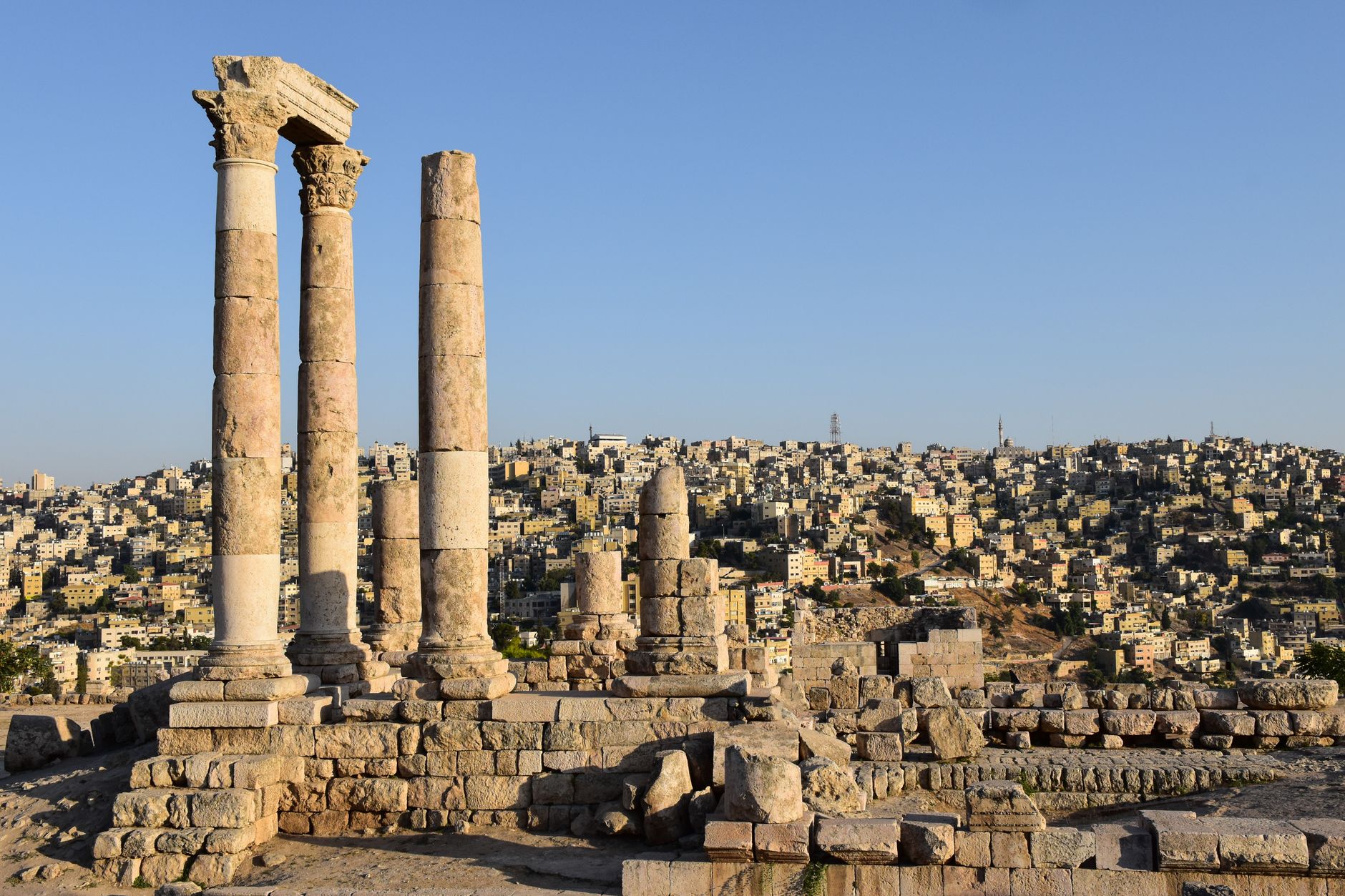 Majestic view of the Temple of Hercules ruins against Amman's sprawling cityscape.. Photo by AXP Photography on Pexels