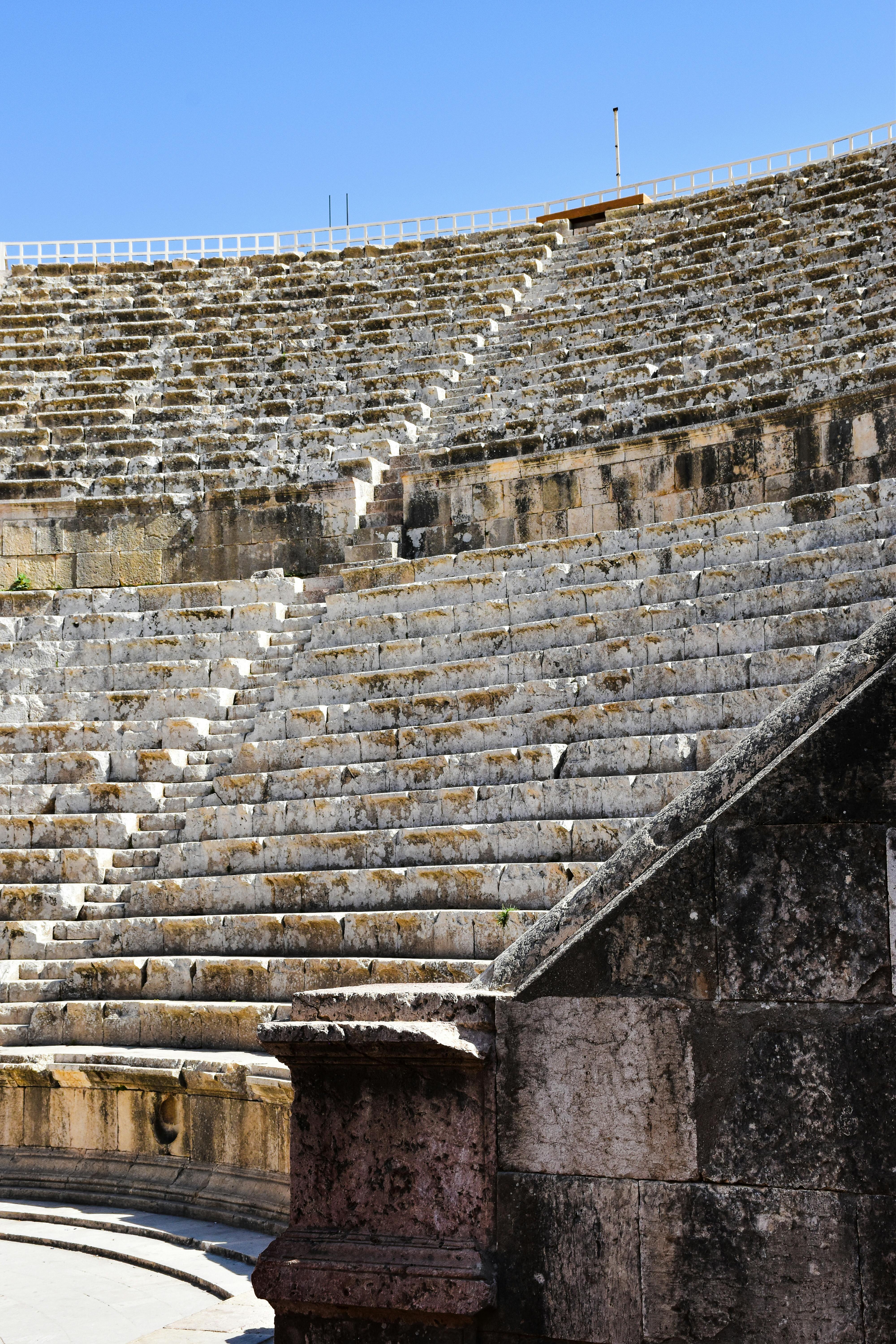 Free Explore the well-preserved ruins of an ancient Roman theater in Amman, capturing history and architecture. Stock Photo