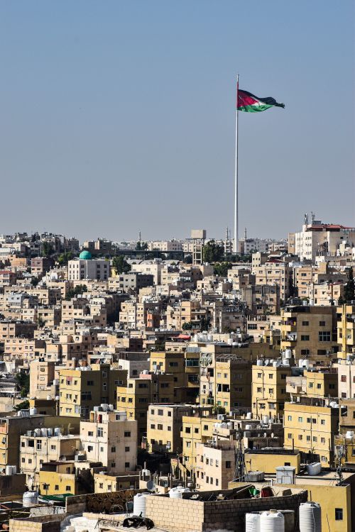 Free Urban landscape of Amman, Jordan with prominent national flag in view. Stock Photo
