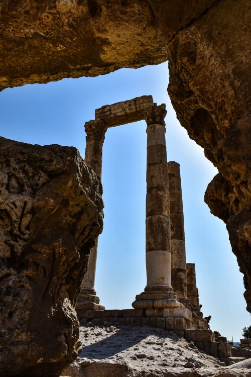 Free Dramatic view of ancient pillars amidst rocky ruins in Amman, Jordan's Citadel. Stock Photo