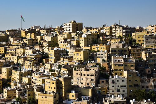 Free Aerial capture of Amman's dense urban architecture with clear blue skies. Stock Photo