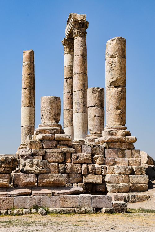 Free Ancient stone columns of the Temple of Hercules under a clear blue sky in Amman, Jordan. Stock Photo