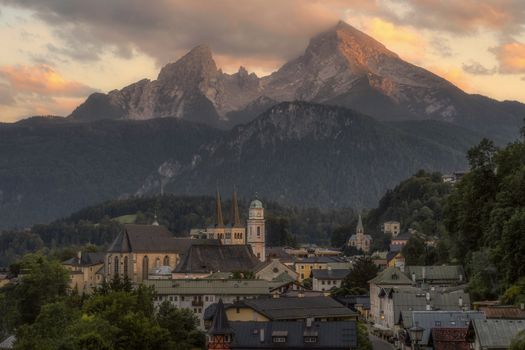Picturesque view of Berchtesgaden village with Watzmann mountain backdrop at sunset. Perfect for travel enthusiasts.