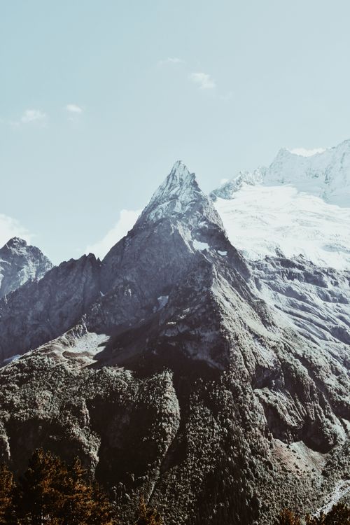 Free Breathtaking view of towering snow-capped mountains with clear blue sky. Stock Photo