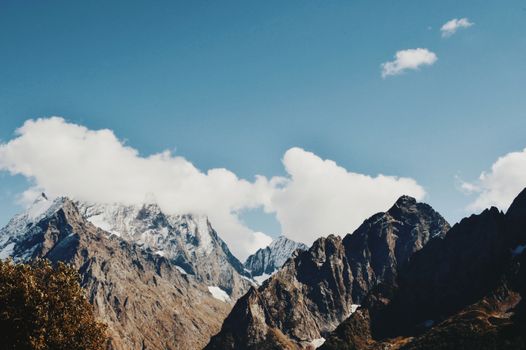 A stunning view of a snow-capped mountain range under a clear blue sky.
