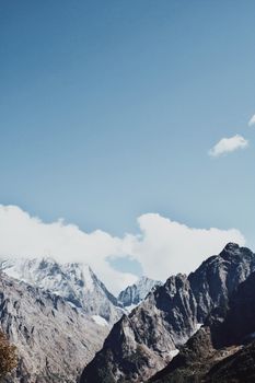 A breathtaking view of snow-capped mountains with clear blue skies, capturing the beauty of nature.