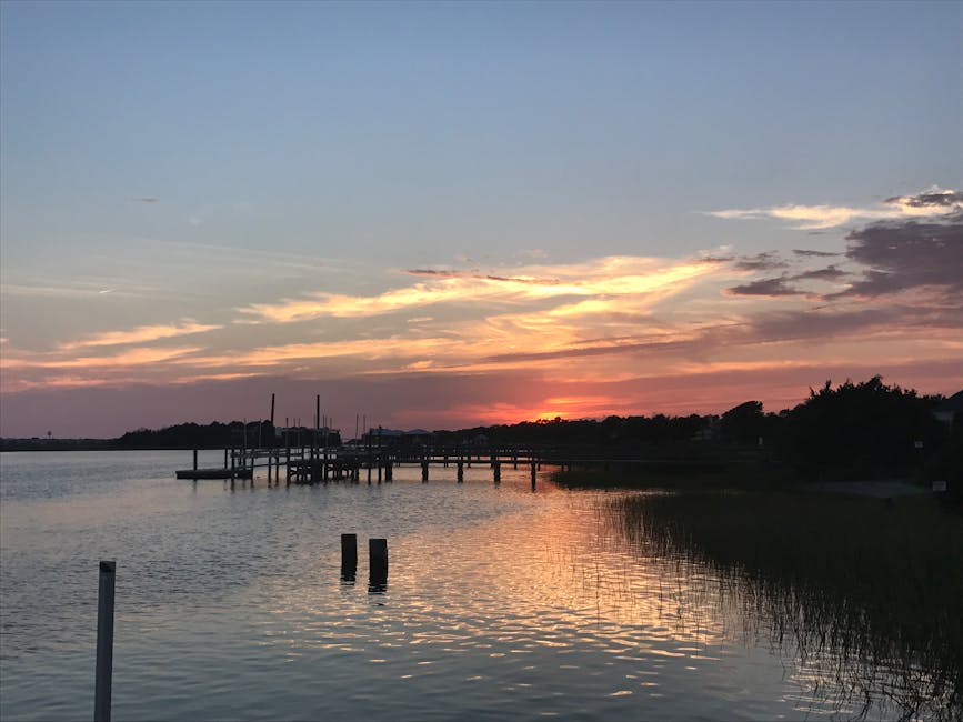 A beautiful sunset at a dock in Myrtle Beach, capturing the reflection on calm waters.